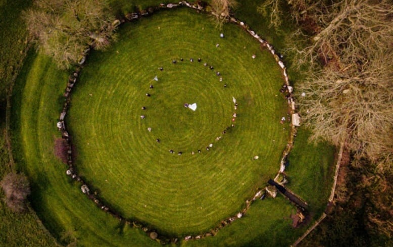 Aerial view of a wedding ceremony held inside an ancient Irish stone ring fort