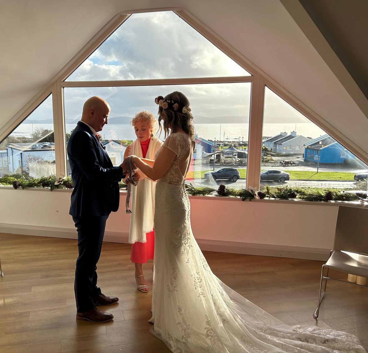Edel Garvey performing a handfasting ceremony, binding the couple's hands with a cord