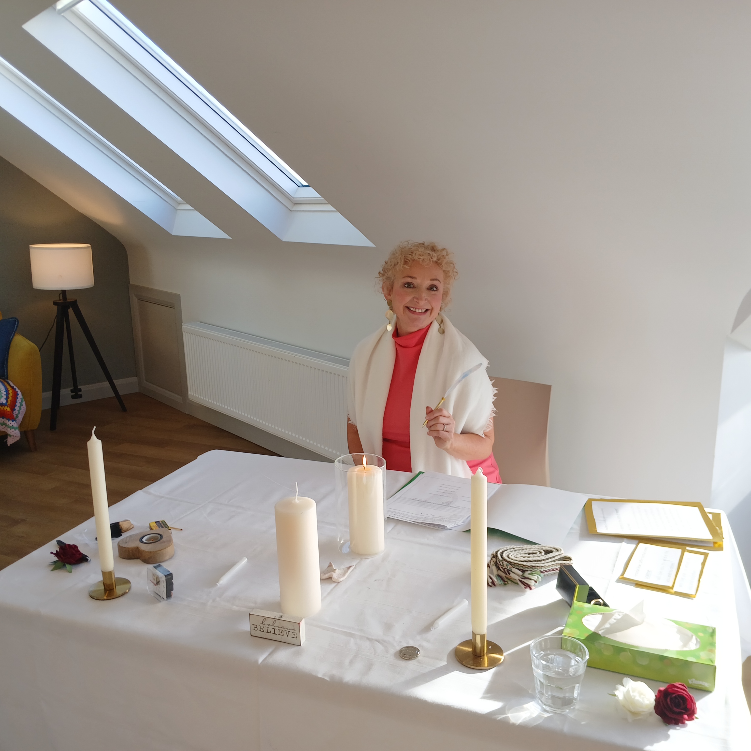 Edel Garvey at a ceremony table, smiling warmly